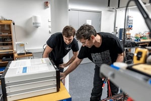 Engineer and customer reviewing electrical test equipment together in a product testing laboratory.