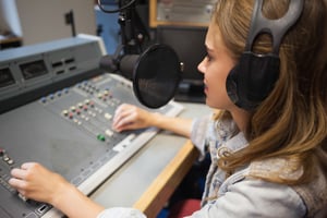 Focused pretty radio host moderating sitting in studio at college-1